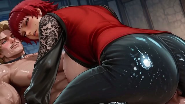 Topless redhead in glossy red-and-black clothing having close-up sex indoors